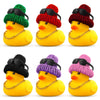 A set of yellow rubber duck car dashboard ornaments with accessories in various colors like green, red, and purple.