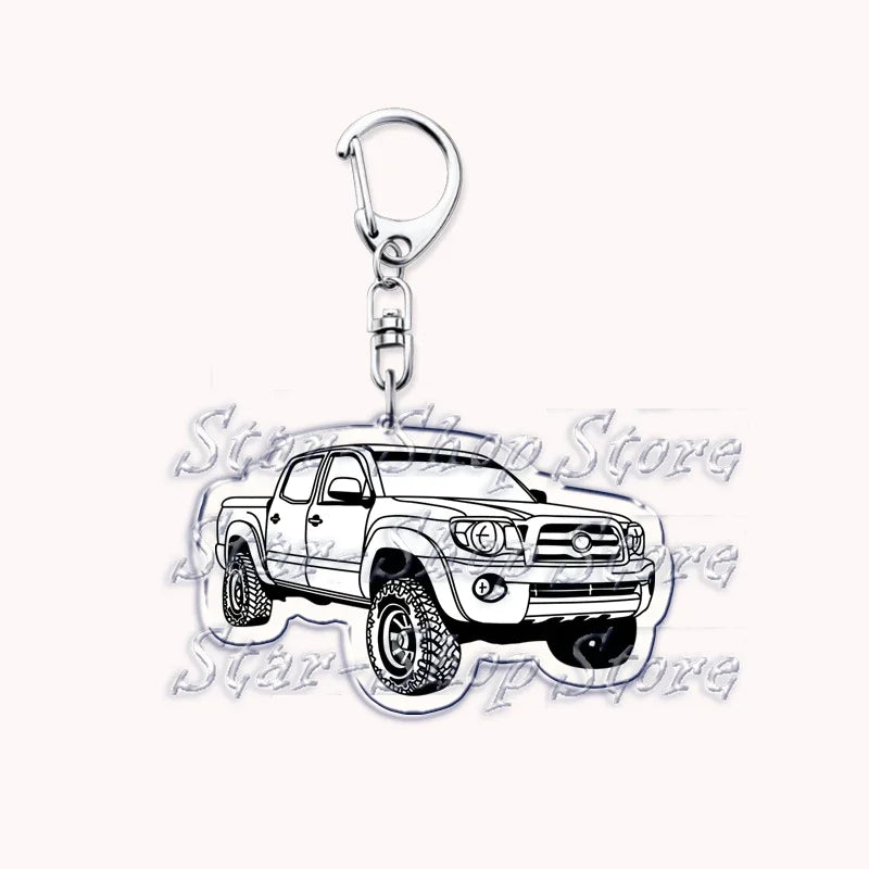A silver metal key ring attached to a miniature model of a Ford F-150 off-road truck.