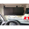 A black leather car sun visor extender is mounted on the ceiling of a vehicle.