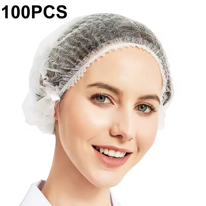A woman is wearing a disposable non-woven bouffant cap for hair, shown in a close-up view.