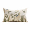 A cream-colored throw pillow cover featuring embroidered floral and grass designs in muted green, beige, and light blue tones
