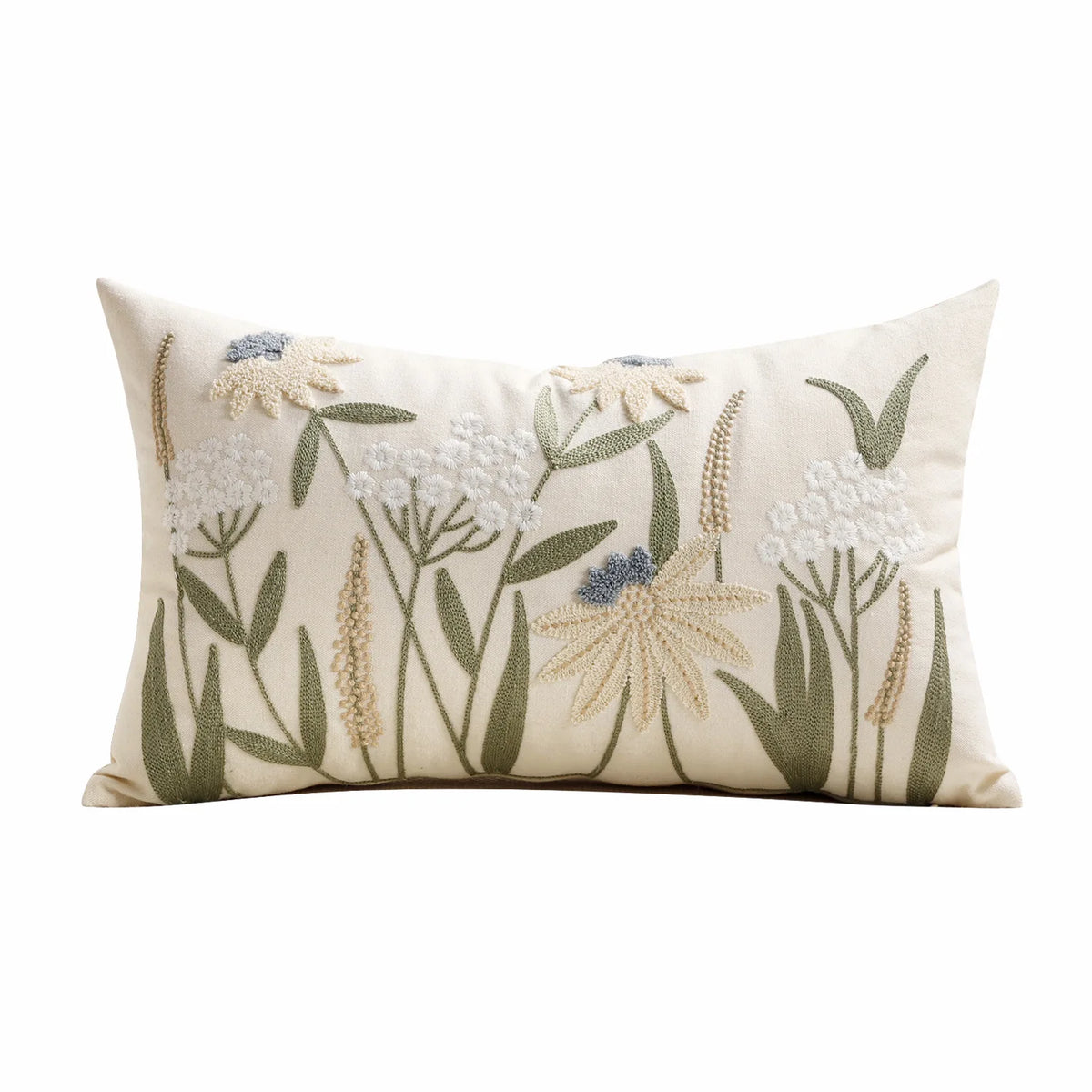 A cream-colored throw pillow cover featuring embroidered floral and grass designs in muted green, beige, and light blue tones