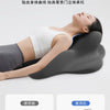 A person is lying down using a gray ergonomic memory foam pillow for a high-back position, demonstrating a posture that preve