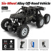 Black six-wheel alloy off-road RC crawler vehicle with large tires and accessories