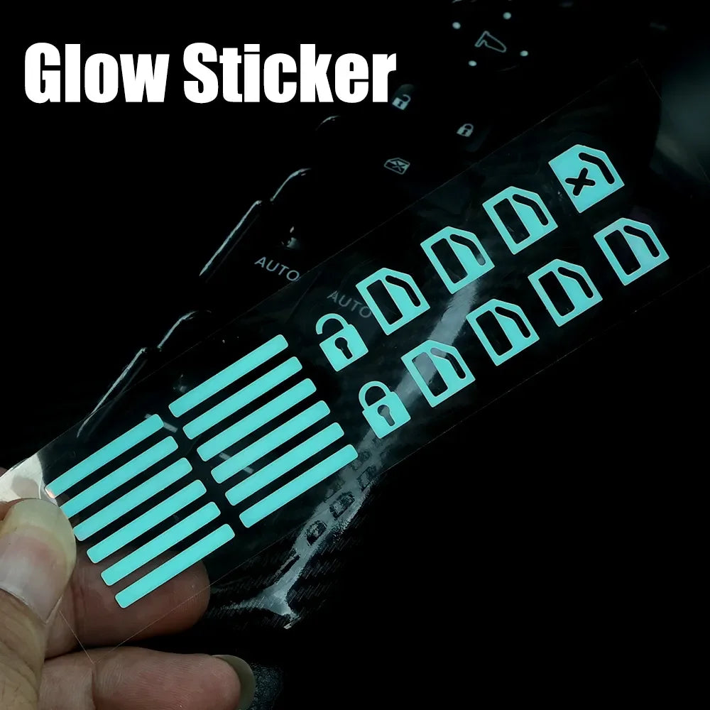 A hand holds a glow sticker featuring various icons and lines for a car window switch.