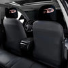 Two black eye print car headrest covers are visible in the interior of a car.