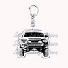 Silver metal key ring with a detailed off-road truck charm.