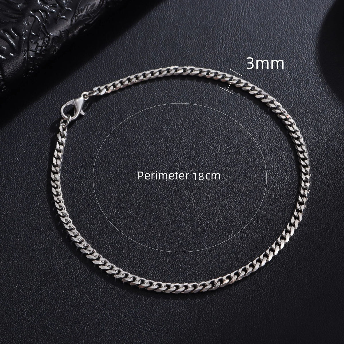 A silver stainless steel Cuban link bracelet with a 3mm chain and a perimeter of 18cm.