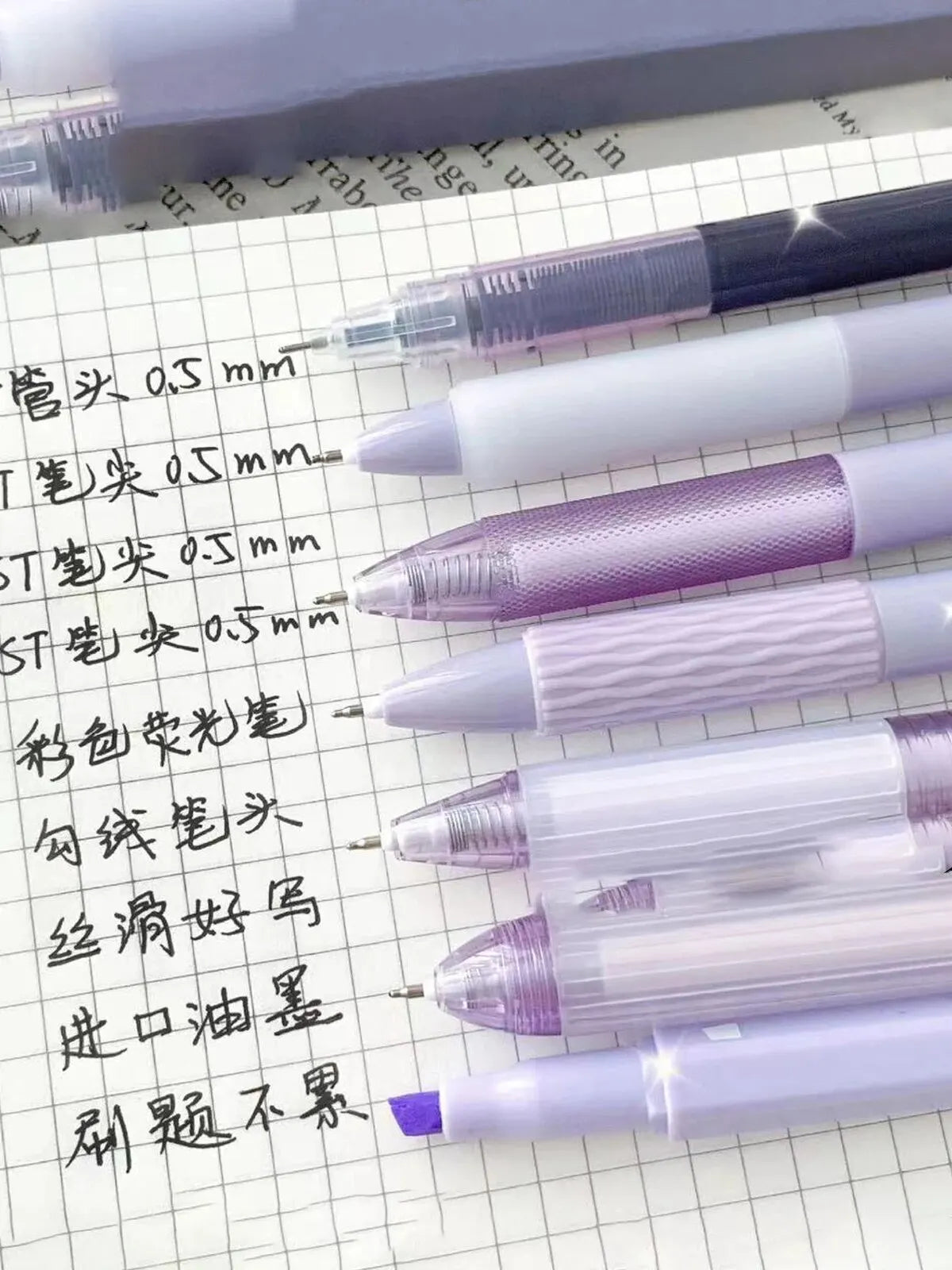 A collection of seven minimalist clear gel pens with 0.5mm fine points are shown on lined paper.