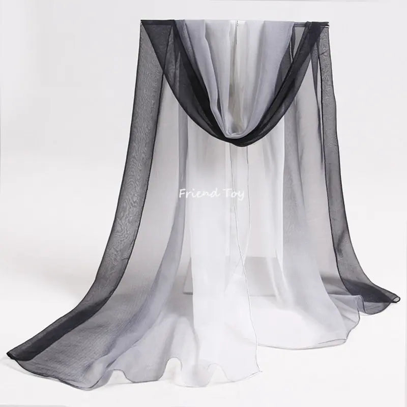 Sheer black and white fabric playsilk draped like a curtain for imaginative play