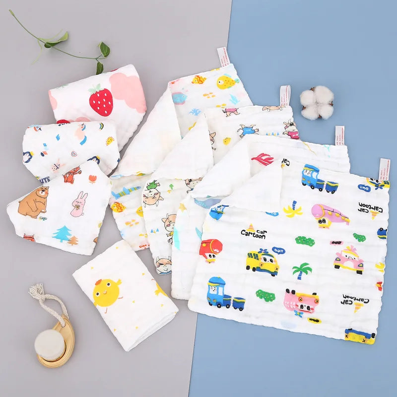 A collection of soft natural cotton muslin baby washcloths featuring various cute illustrations and themes.