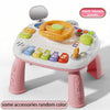 A white baby interactive activity table featuring a yellow steering wheel and various colorful buttons for play.
