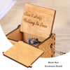 A hand-cranked wooden music box with an accessory board and a lid, made of light wood.