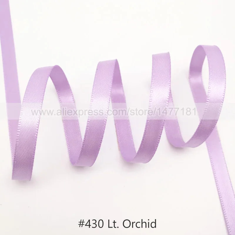 A roll of light purple satin ribbon used for crafting or gift wrapping.