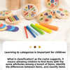A collection of wooden color sorting toys and blocks for toddlers, including rings, discs, and colored rods.