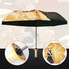 A folding umbrella featuring a Demon Slayer theme with a yellow and black patterned canopy and a gold handle.