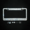 A rectangular crystal rhinestone license plate frame with mounting tabs and small hardware components.