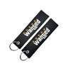 Black nylon keychain with embroidered wanted text and steel spring clip