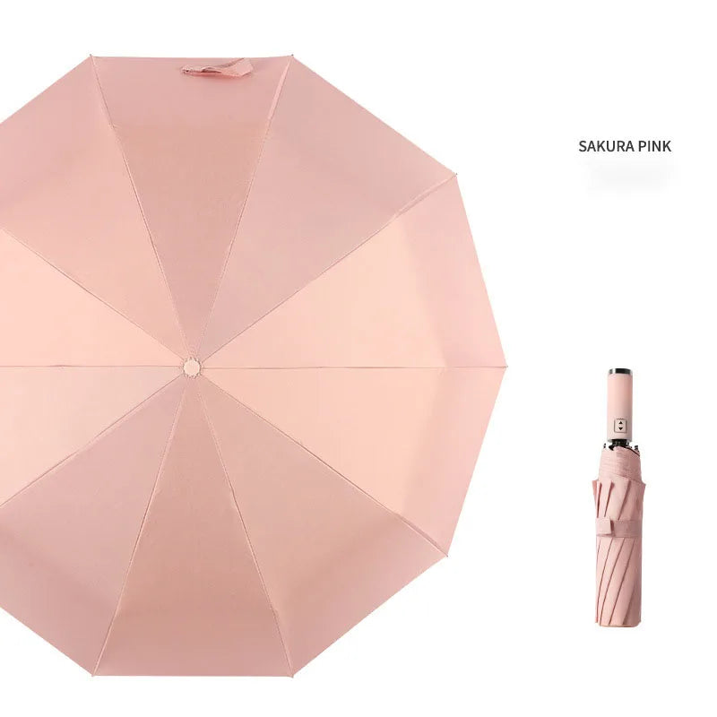 A pink umbrella with a folded canopy and an attached handle is shown.