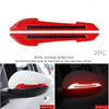 Two red reflective strips recommended to be stuck to the back of a rearview mirror for enhanced visibility