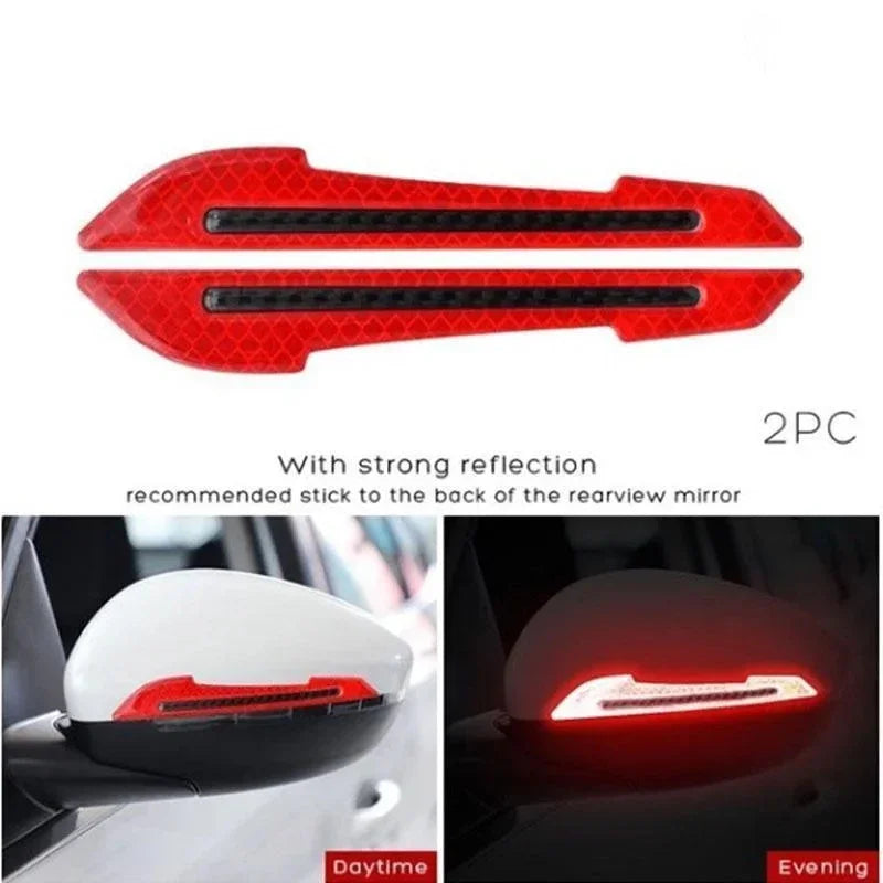 Two red reflective strips recommended to be stuck to the back of a rearview mirror for enhanced visibility