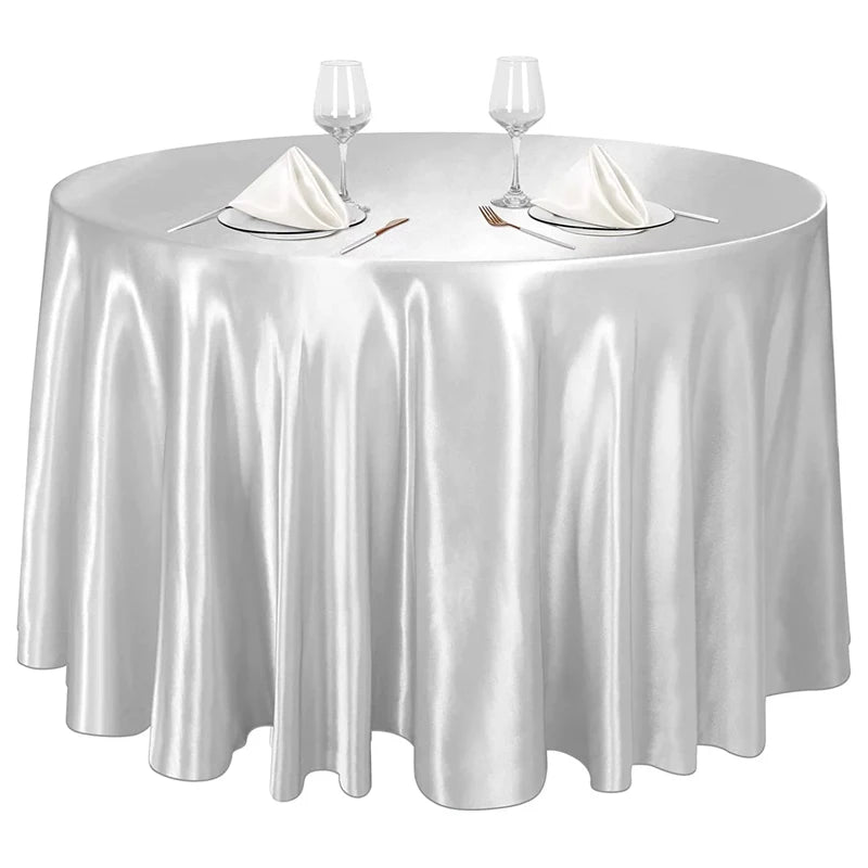 Elegant silver satin round tablecloth set for weddings and events with glassware and cutlery