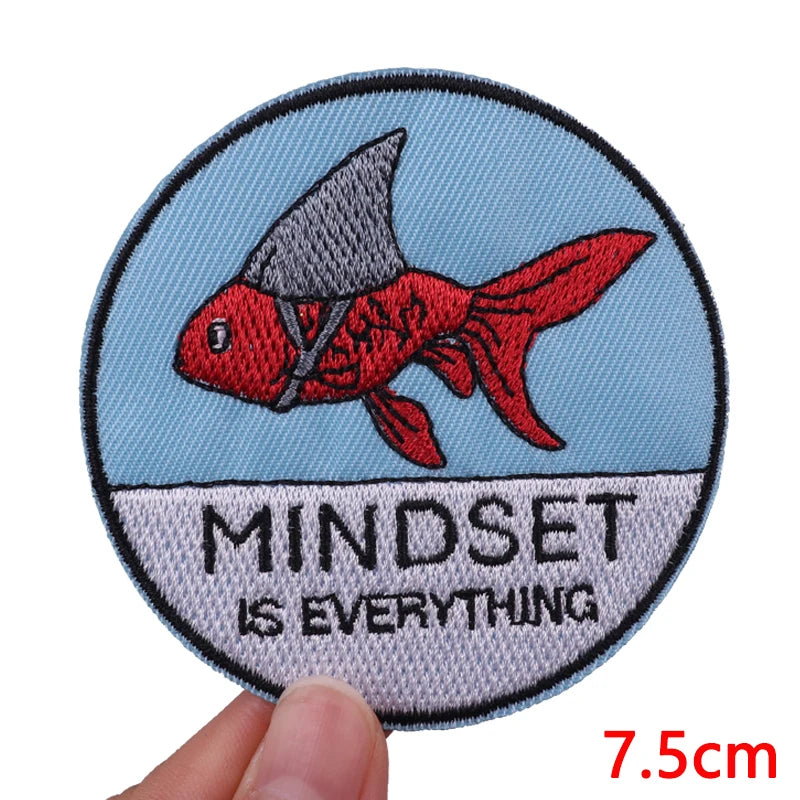 Embroidered patch featuring a red fish silhouette on a light blue background with the text MINDSET IS EVERYTHING
