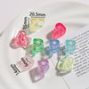 Assortment of colorful acrylic alphabet beads displayed on a white plate.