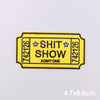 Yellow embroidered iron-on patch with the text SHIT SHOW and a ticket number 742126