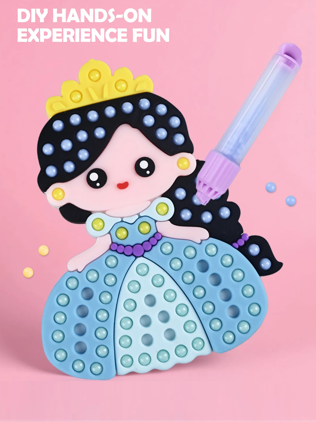 A pink and blue DIY craft kit featuring a princess character with a crown, made from plastic beads and silicone components.