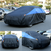 Black and blue waterproof car cover protecting a vehicle in an outdoor parking lot.