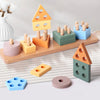 A collection of wooden sorting and stacking toys in various pastel colors, including geometric shapes and cylinders.