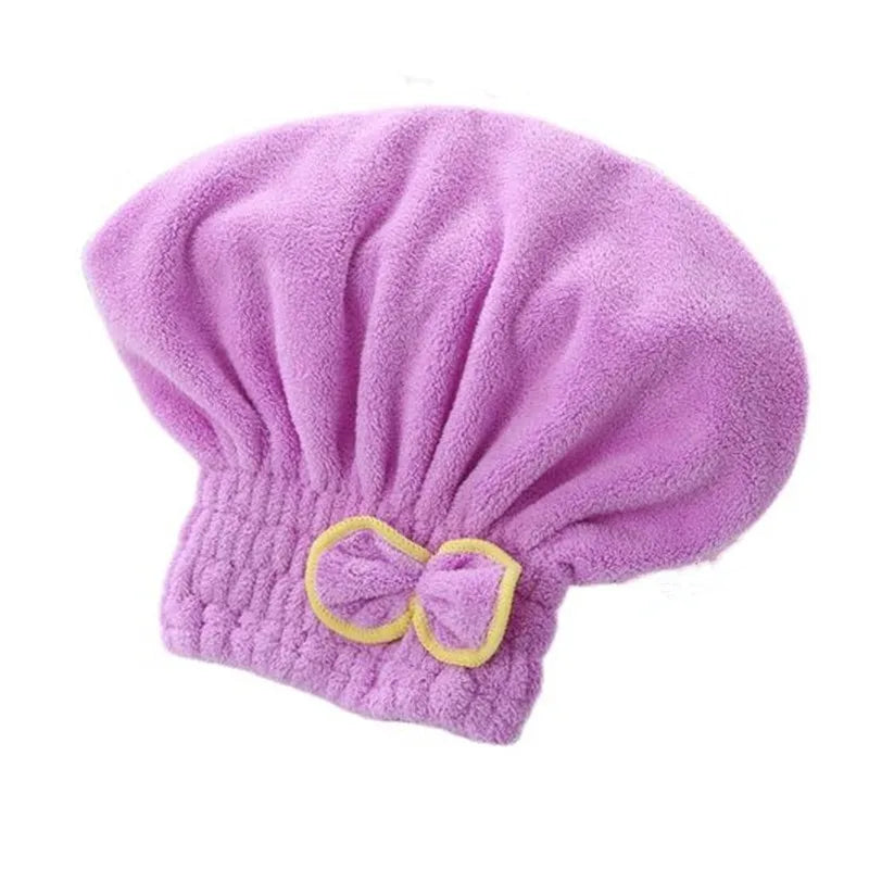 A purple microfibre quick-dry hair towel wrap with a yellow bowknot.