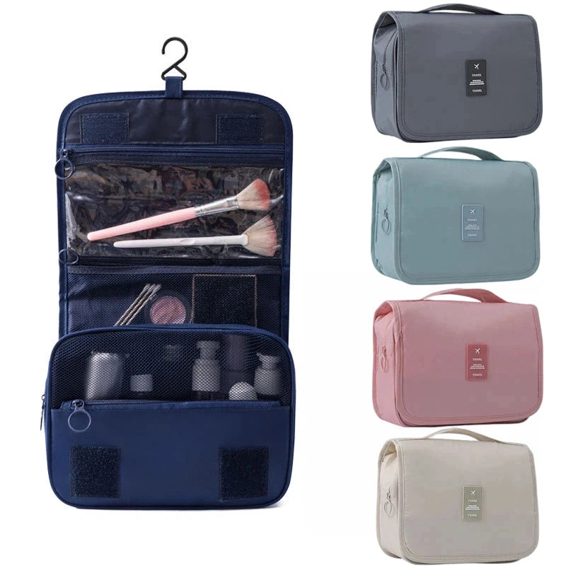 A navy blue travel makeup bag with a hanging hook, showing an open compartment containing brushes and other toiletries.