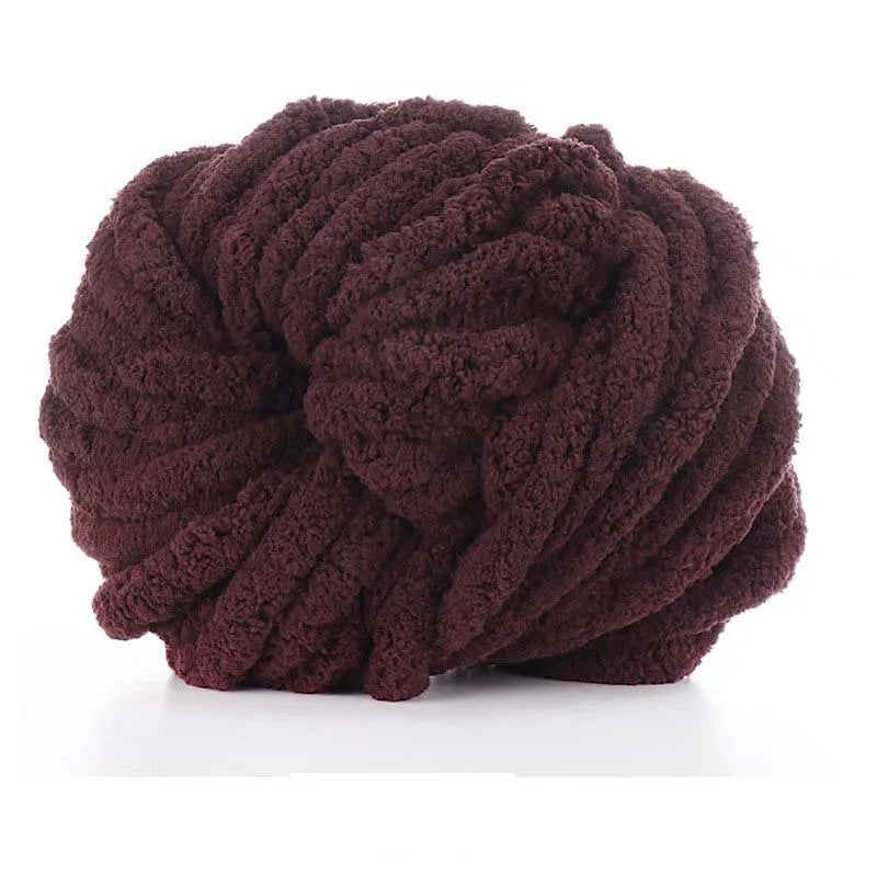 A ball of dark brown chunky acrylic yarn used for knitting and crochet