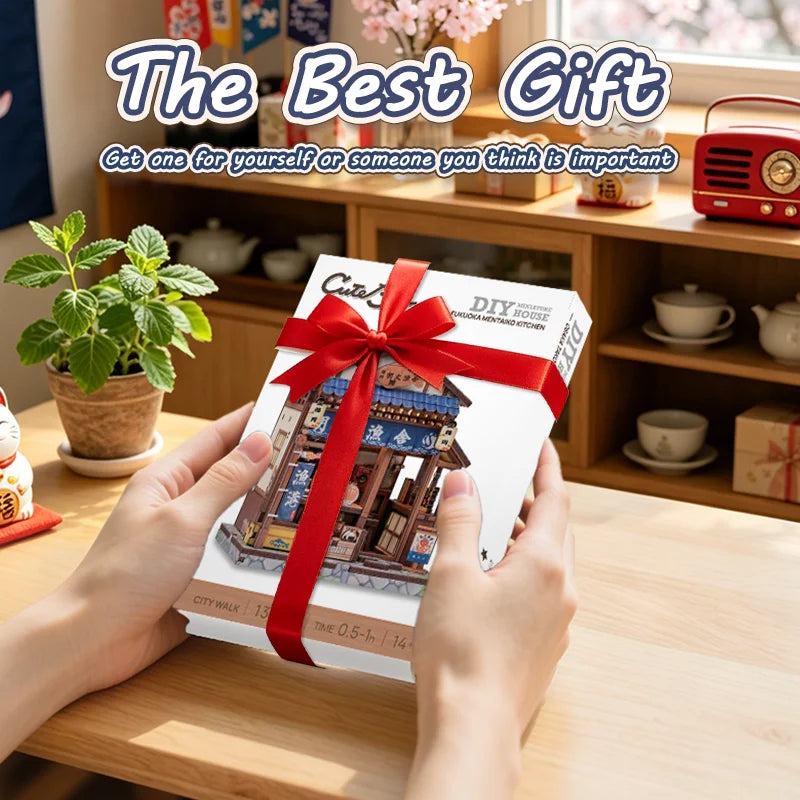 Hands hold a box of a Japanese miniature book nook kit with lighting on a wooden table.
