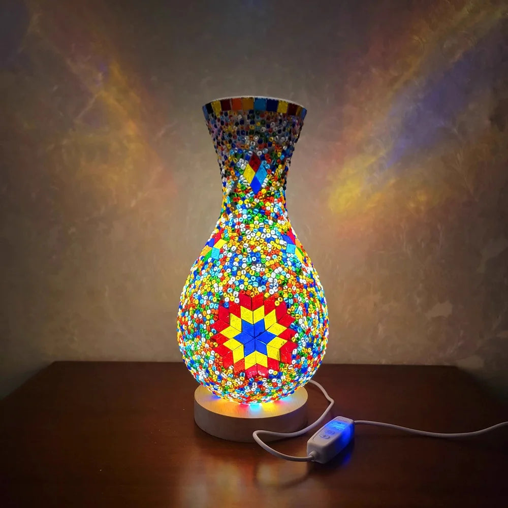 A handcrafted Turkish mosaic table lamp with warm LED glow, featuring colorful glass pieces in a vase shape.