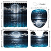 A set of ocean wave themed bathroom accessories including a shower curtain, rugs, and toilet lid cover.