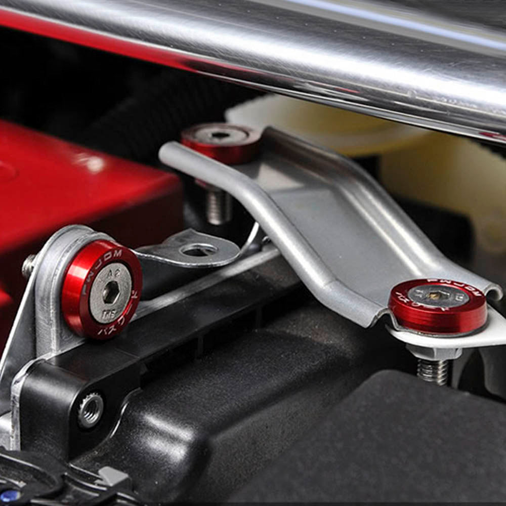 Close-up of an aluminum JDM fender washer and bolt kit assembly with red and silver components.