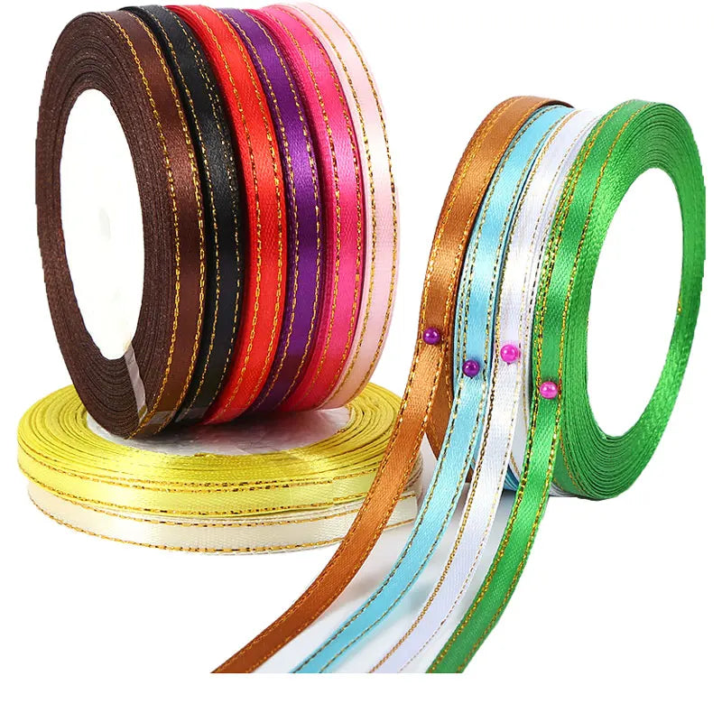 A collection of satin ribbons in various colors including brown, red, purple, orange, and green, displayed on a spool.