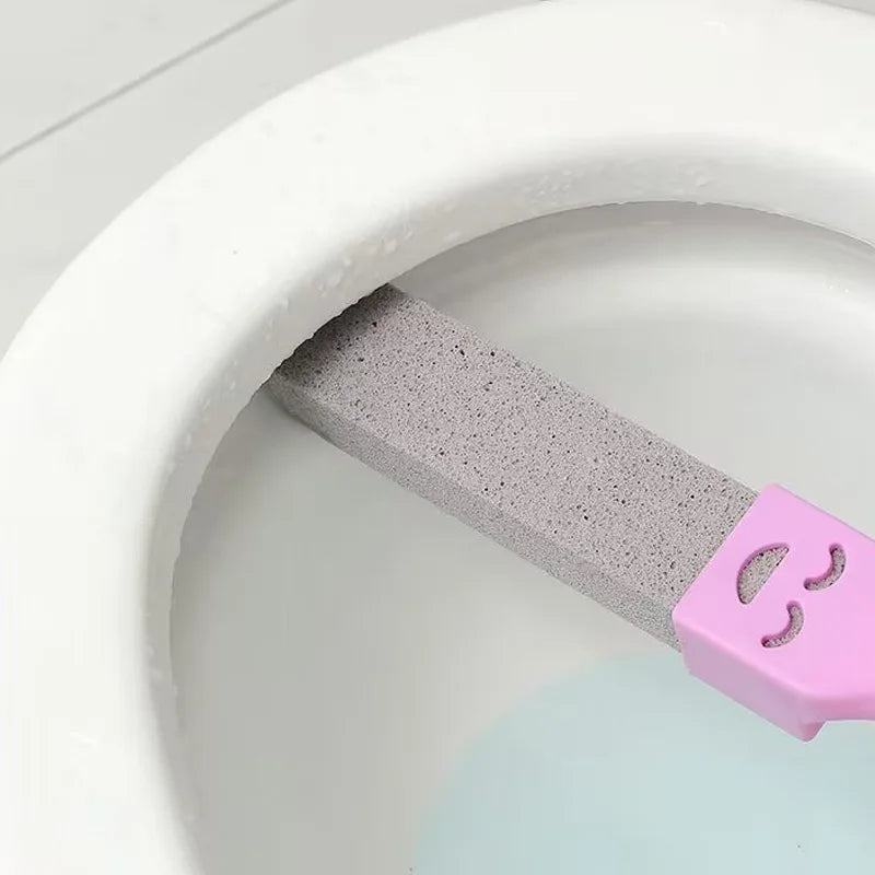 A pink pumice stone cleaning stick is shown inside a white toilet bowl.