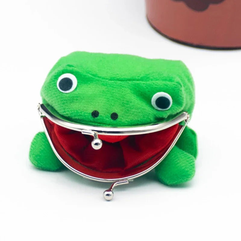 A bright green plush frog coin purse with a red lining and silver clasp, featuring large black eyes.