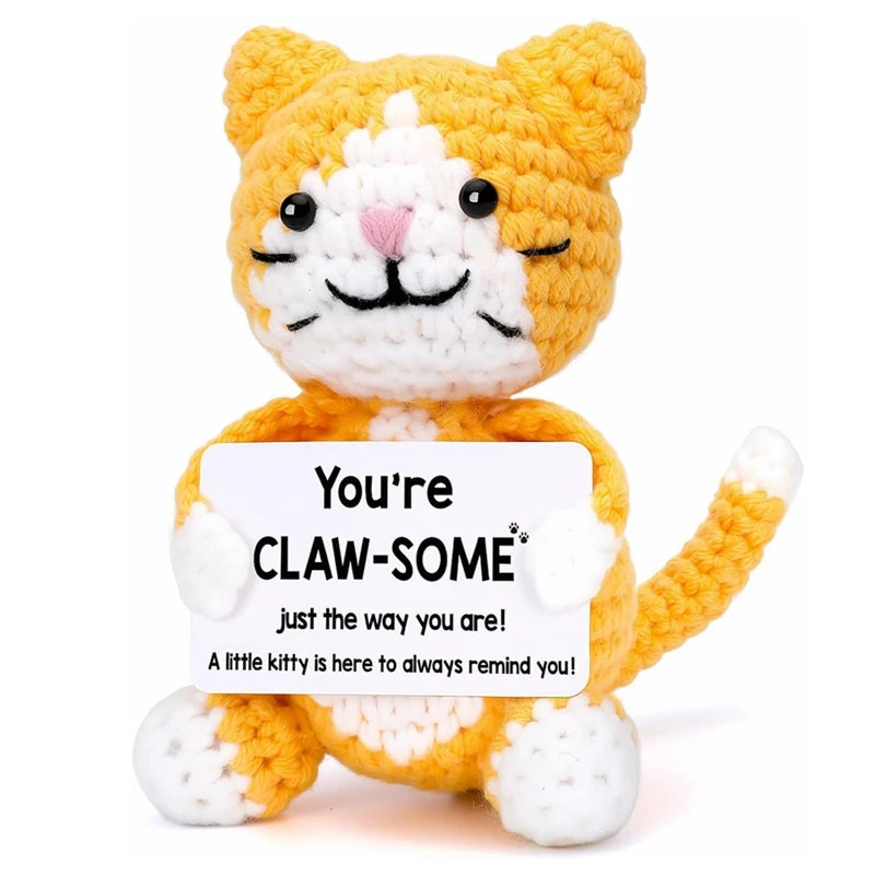 Handmade crochet orange and white cat doll with a message card that reads You're Claw-Some