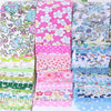 A collection of 40 floral cotton fabric strips in various pink, green, and blue patterns for quilting and patchwork