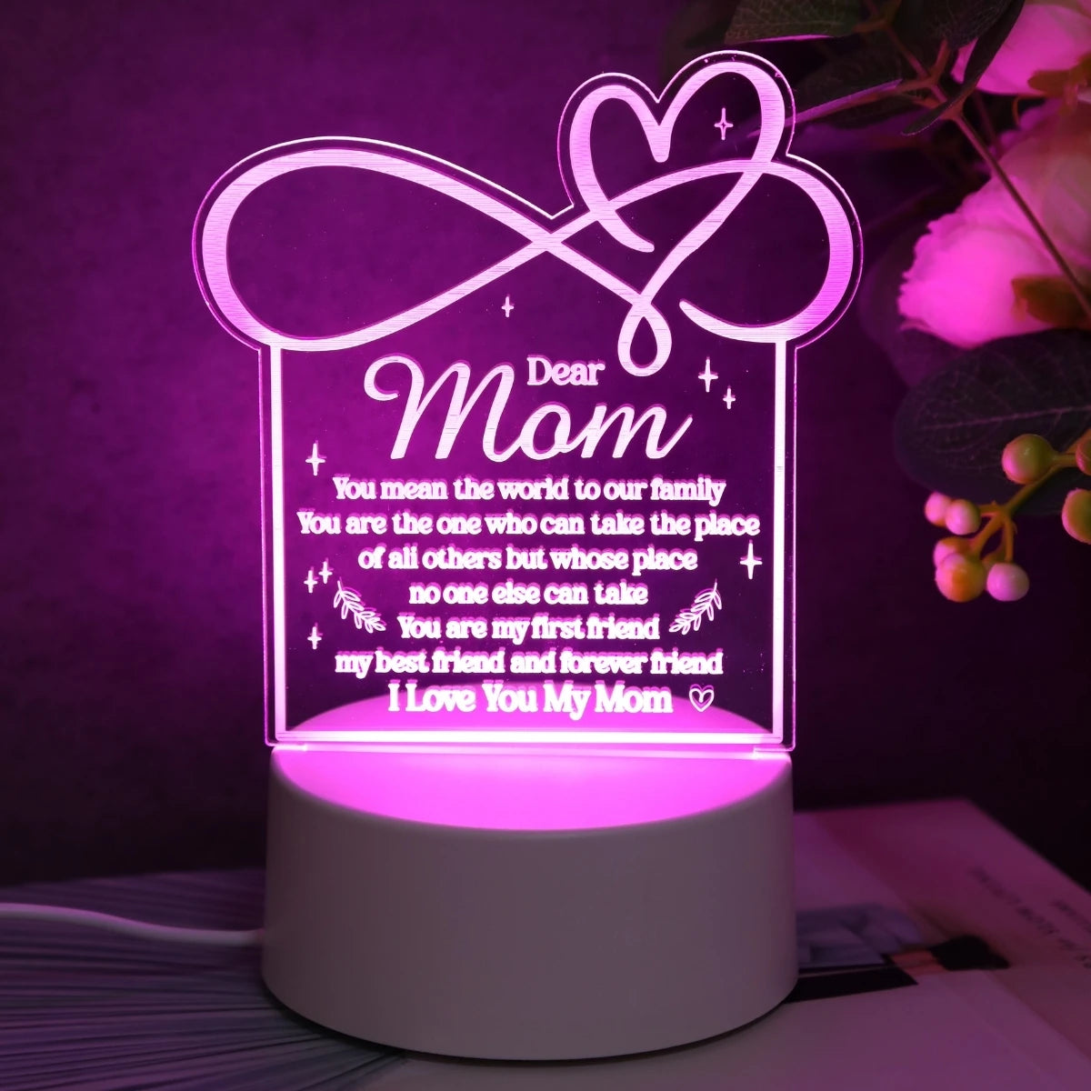 A glowing acrylic night light shaped like a heart with text reading Dear Mom and loving messages.