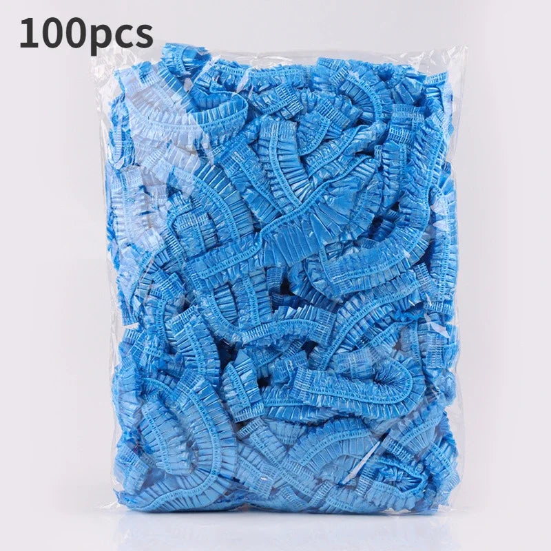 A plastic bag containing 100 pieces of blue disposable transparent waterproof shower caps.