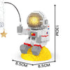 A LEGO astronaut figure wearing a helmet with a glowing yellow light, standing on a yellow base.