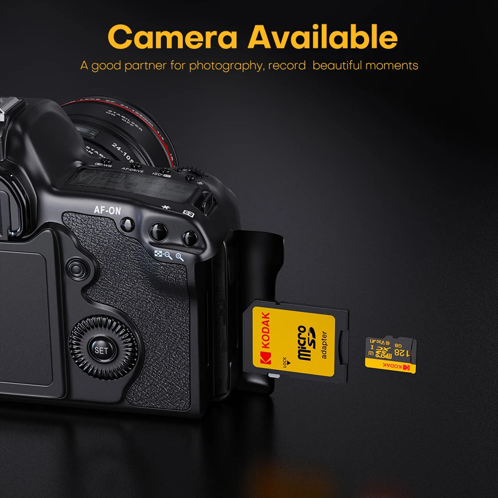 A black camera body with a Kodak adapter and a microSD card visible on a dark surface.
