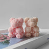 Two pink silicone bear hug roses are displayed on a white box with floral artwork.