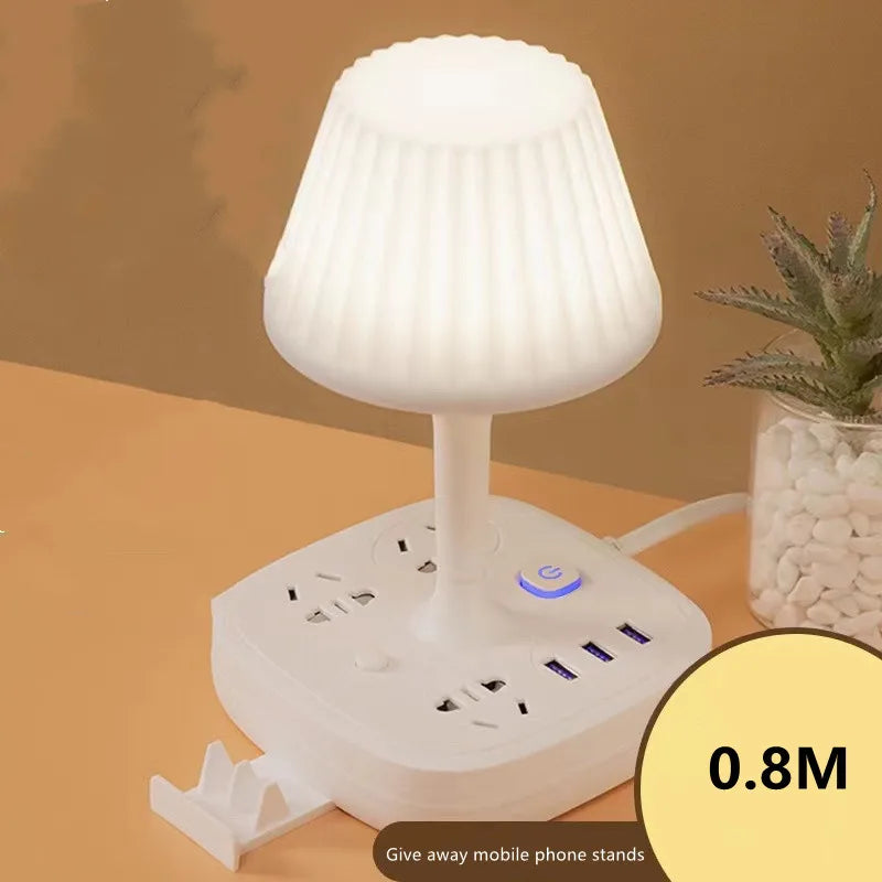 A white multifunctional desk lamp with a shade, USB charging hub, and phone holder, shown on a wooden surface.